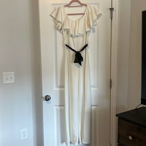 European, white, stretchy jumpsuit with black belt. Size: S